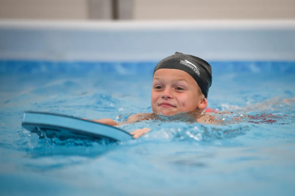 boy swimming with float at Swim:ED school swimming programme which is a portable swimming pool used for primary school swimming lessons